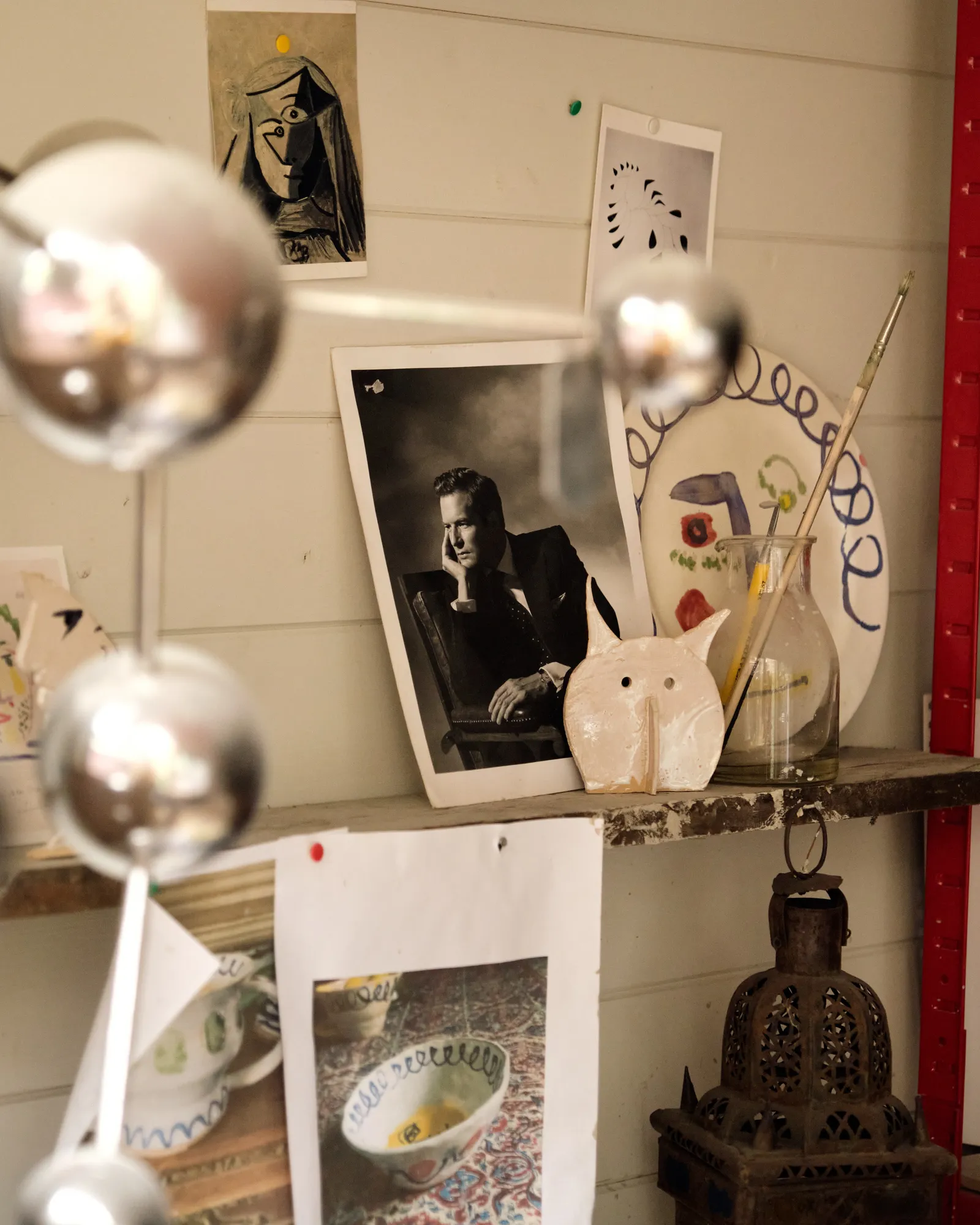 Photographs are interspersed around the stuido.