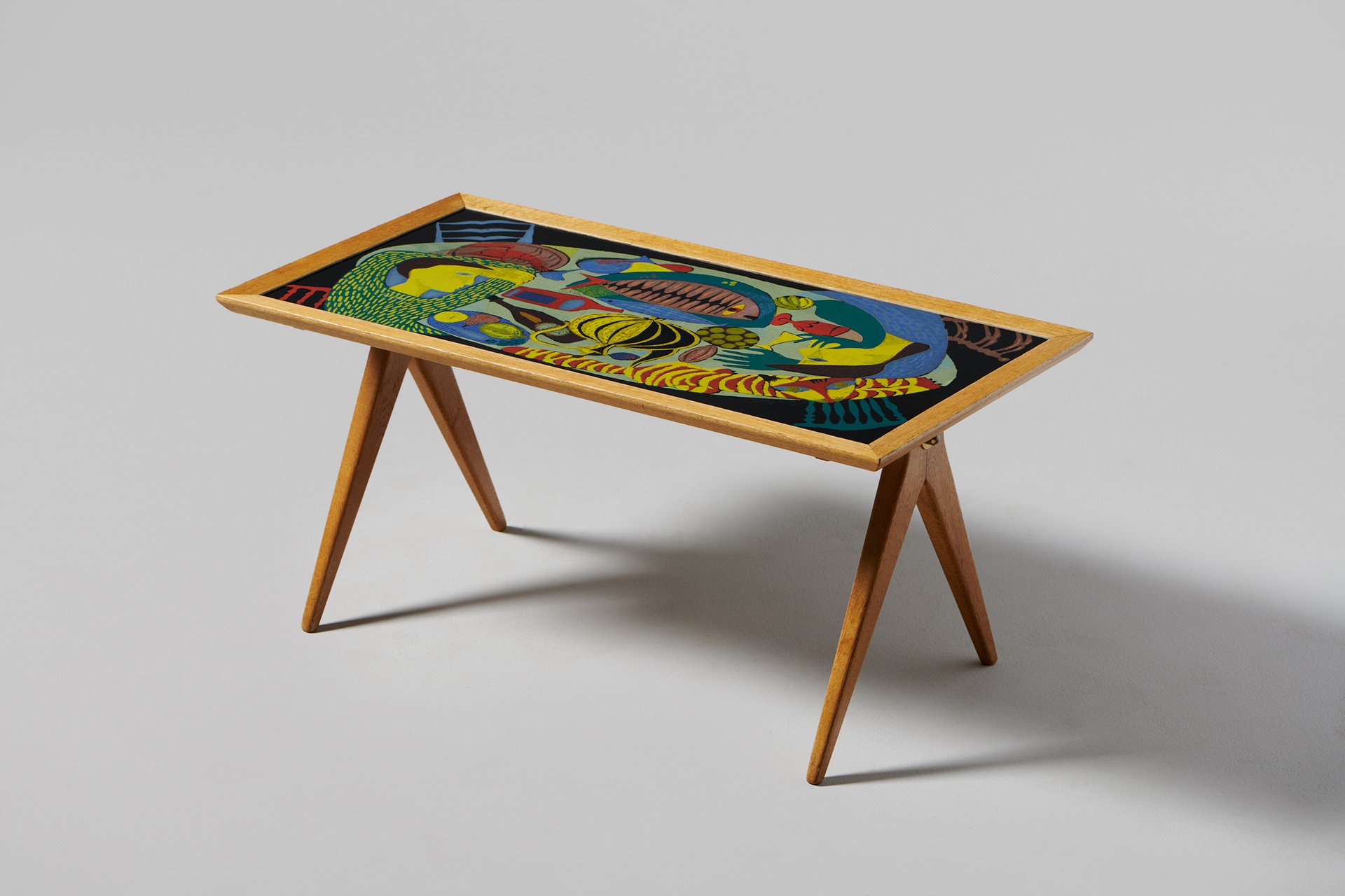 Stig Lindberg, Table from the NK Triva series, 1950s, Enamelled top signed "Stig L. -52", Metal tag "AB NK Made in Sweden", The oak base designed by David Rosen, Produced by NK Nordiska Kompaniet.