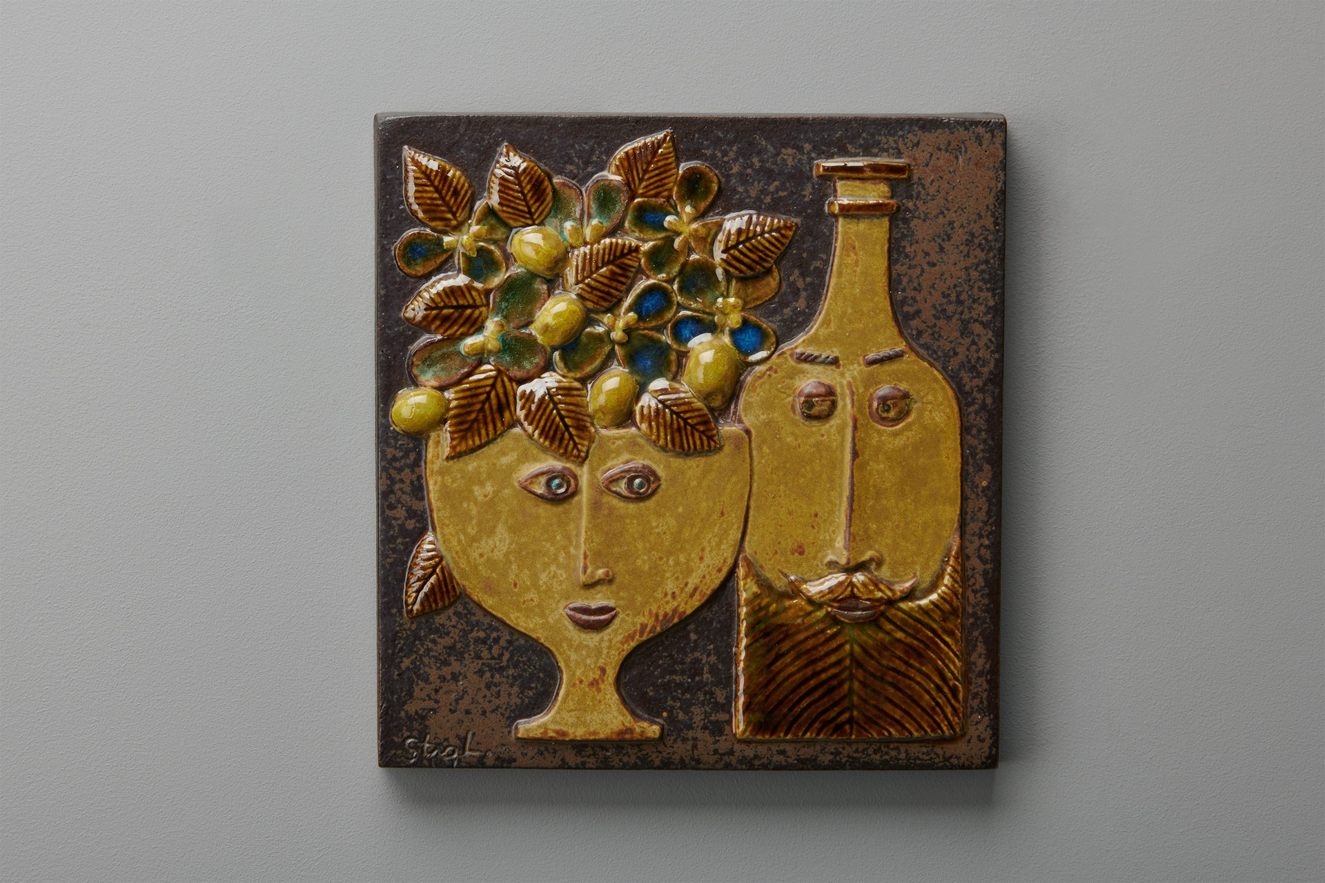 Stig Lindberg, Wall Plaque, 1972, Incised, carved and painted ceramic, details in a shiny glaze, Impressed on the back " FRÅ N KONSUM STOCKHOLM 1972", Incised artist signature on the front " Stig L", Produced by Gustavsberg Studio.