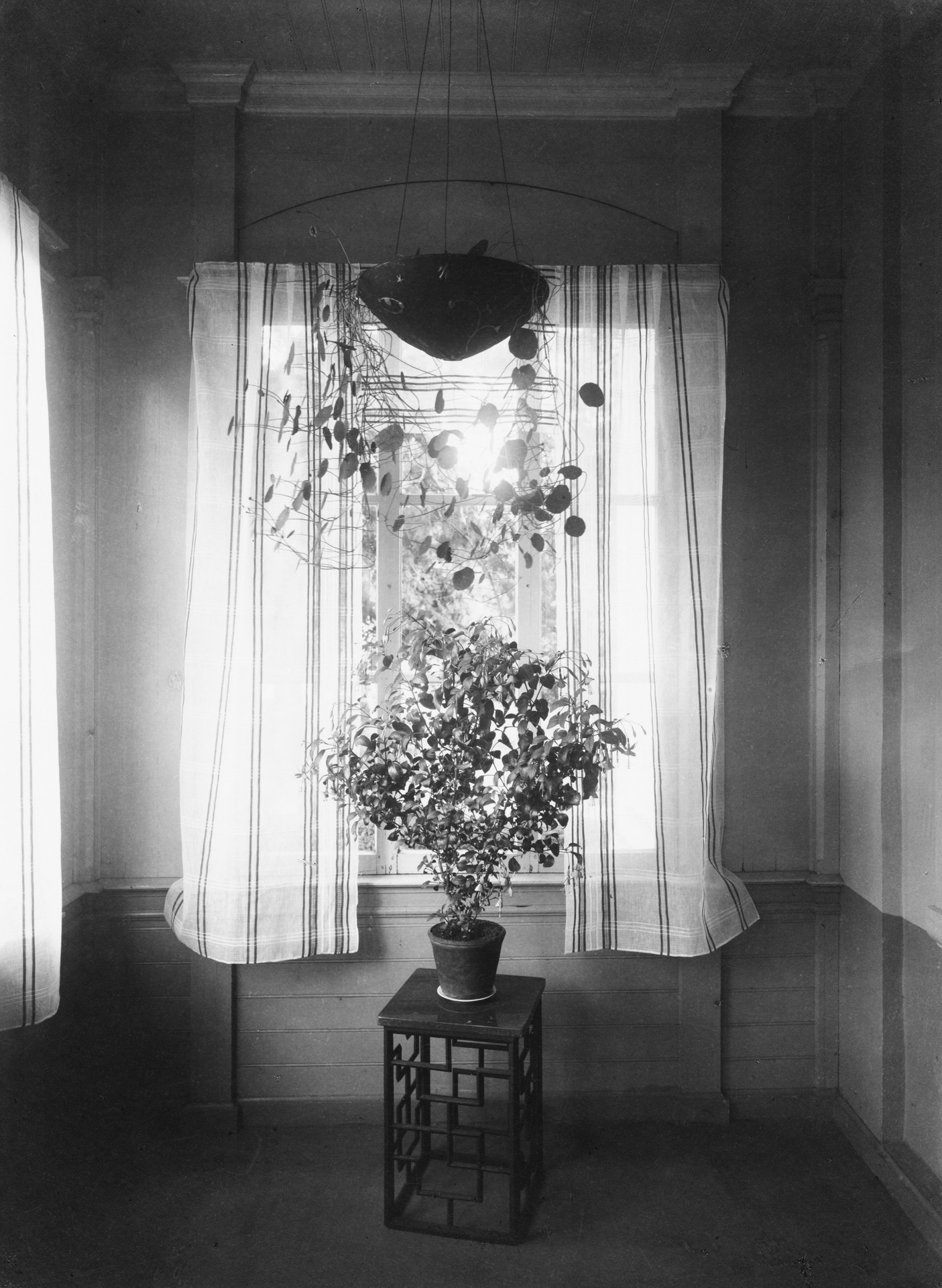 Interior shot from the 1920s. 'Mikrokosmos' urn, designed by Olof Hult in 1922, hanging to the ceiling. 'Blomster' Side Table, designed by Carl Hörvik.  (source: www.nafveqvarn.com)