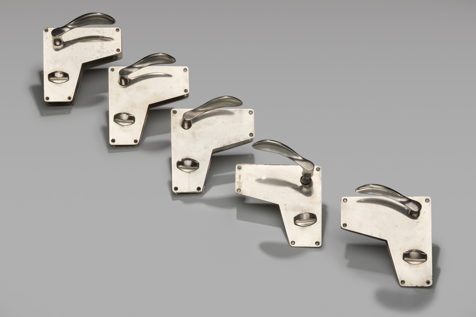 Set of Five Early 'AJ' Door Handles and Lock Plates