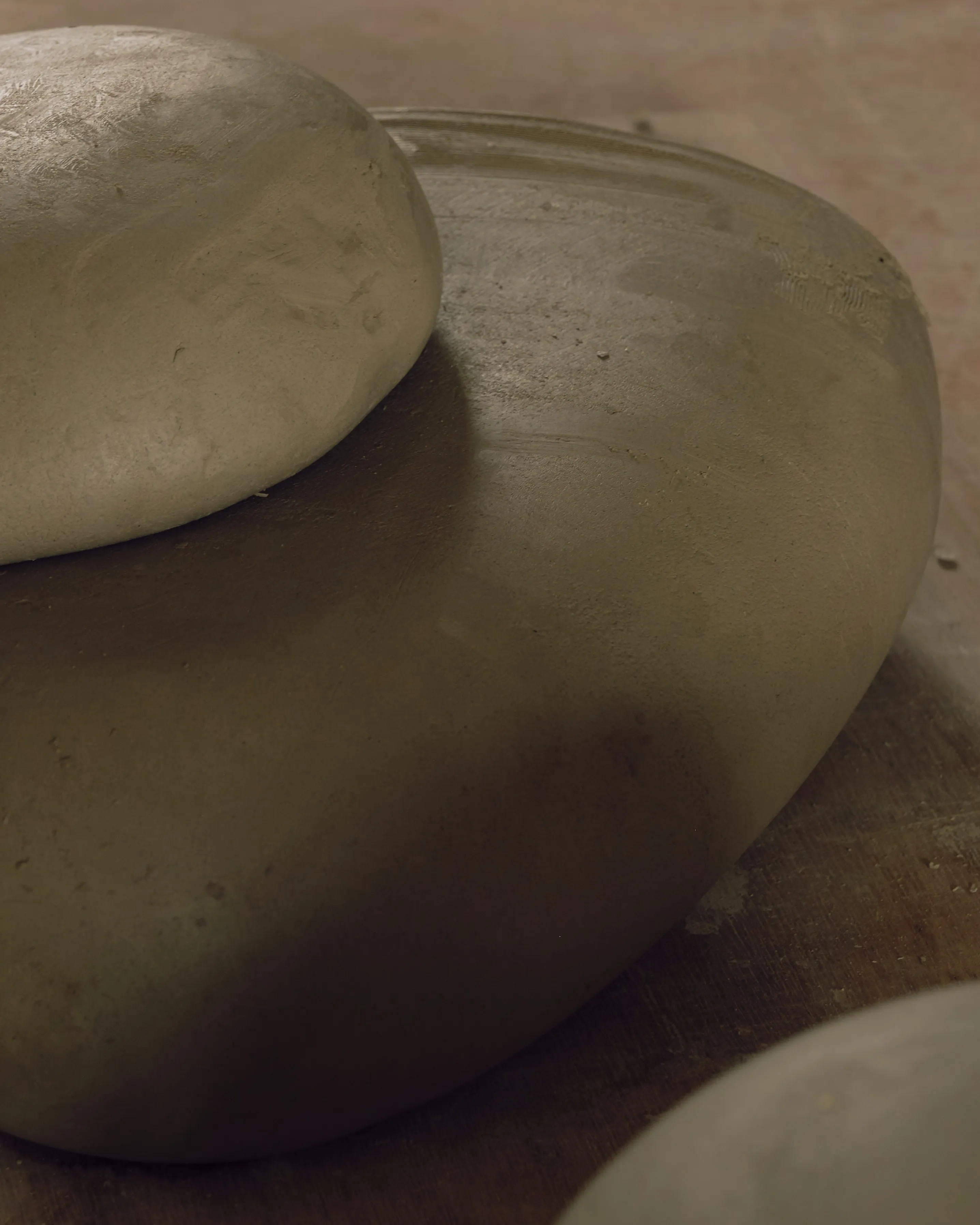 A collection of ceramic stones that will be glazed and fired in different colours.