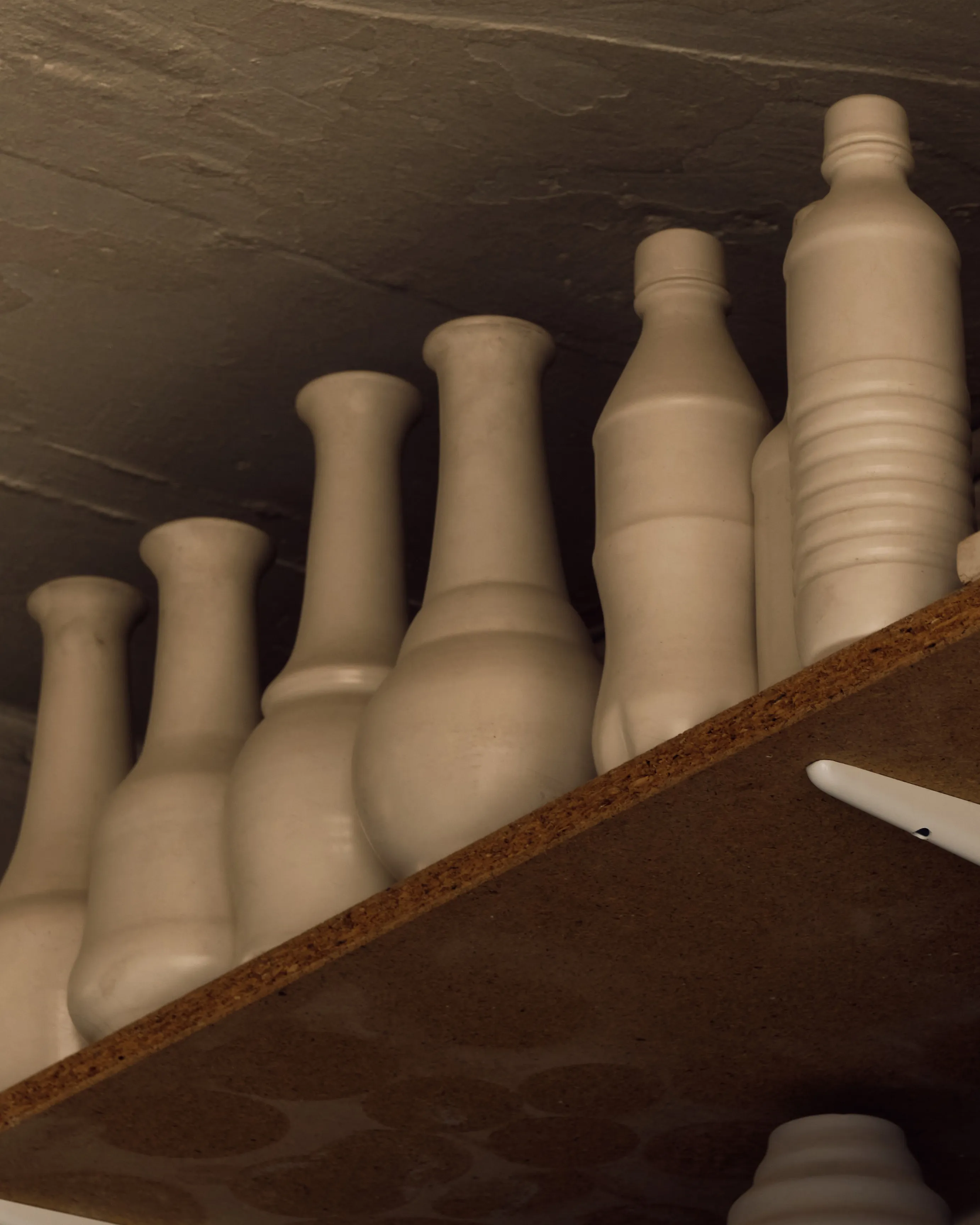 A visual diary of thirty years of making, the studio includes ceramic casts of soft drink bottles.