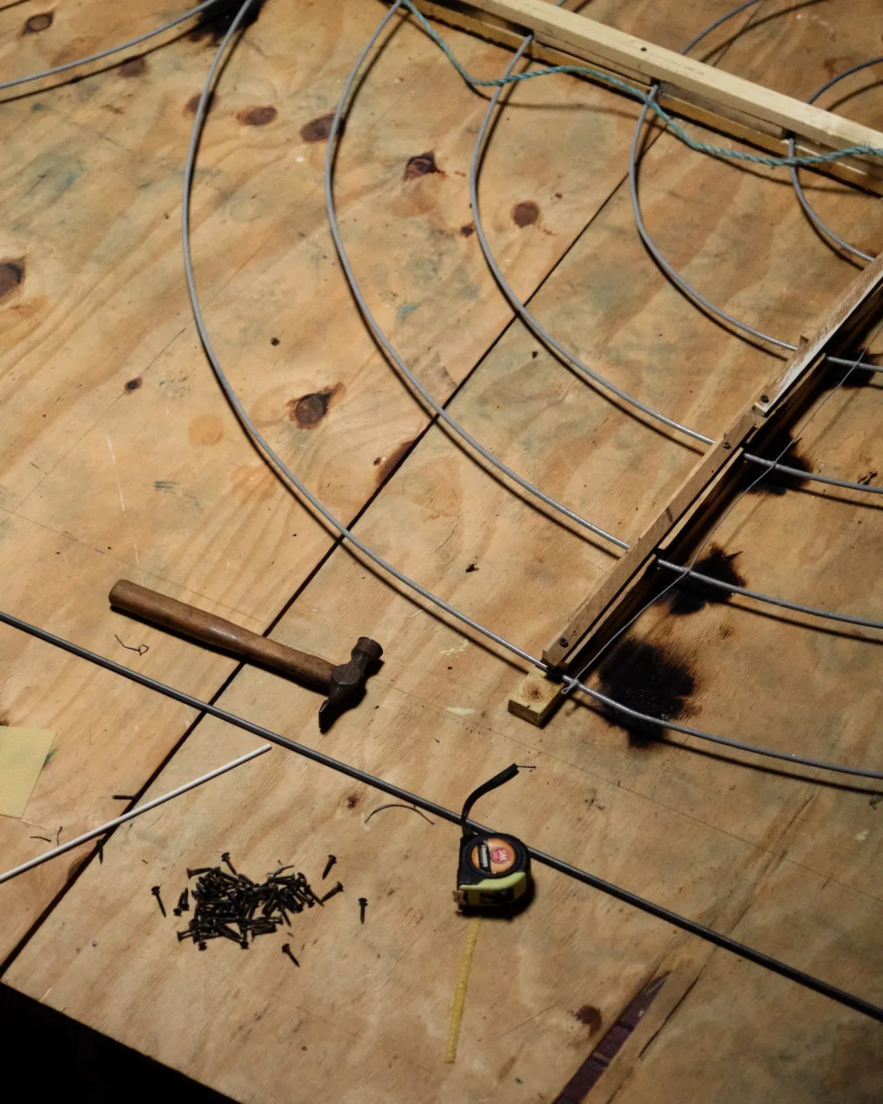 The studio is a vast concrete expanse lit by key skylight windows beaming down on worktables.