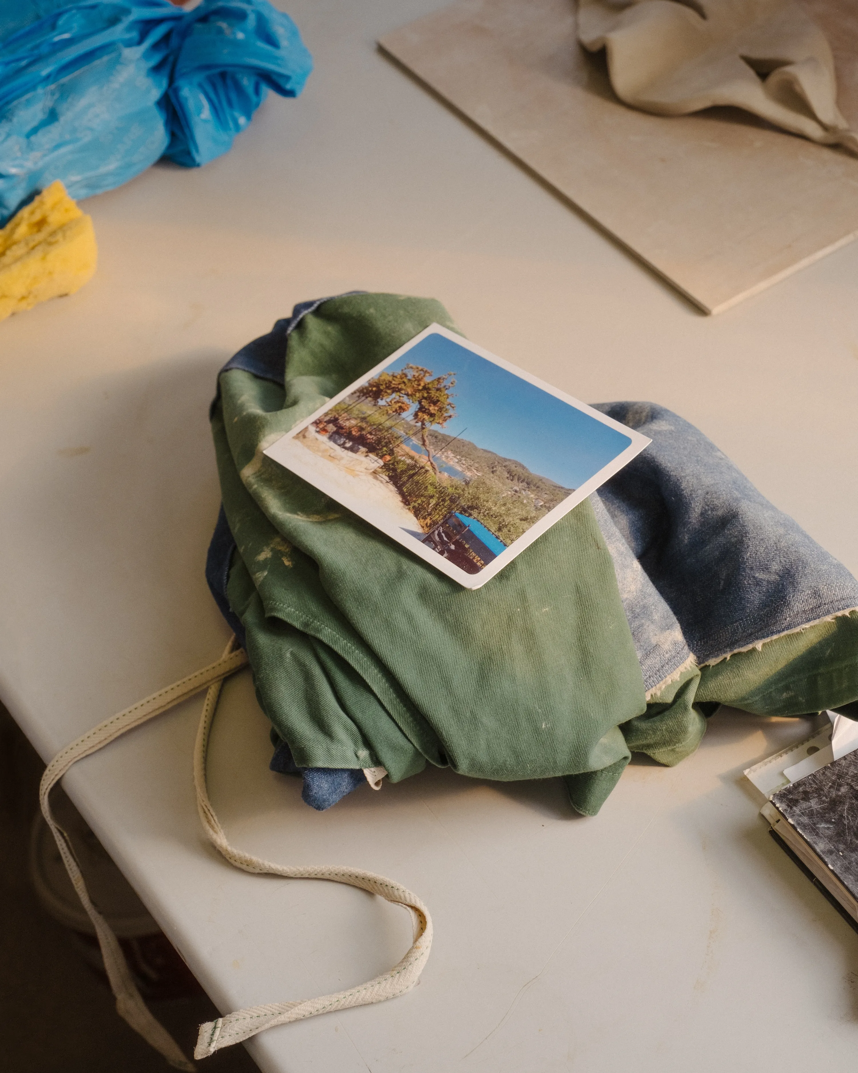 A postcard from Greece rests on Pallas' apron