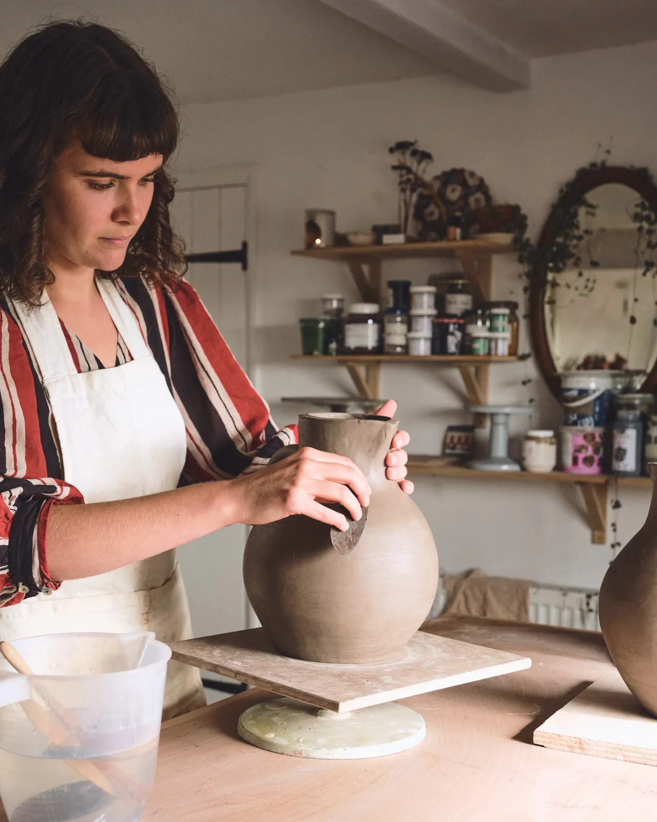 Traditional Bideford jugs use a honey glaze with sgraffito of suns and flowers