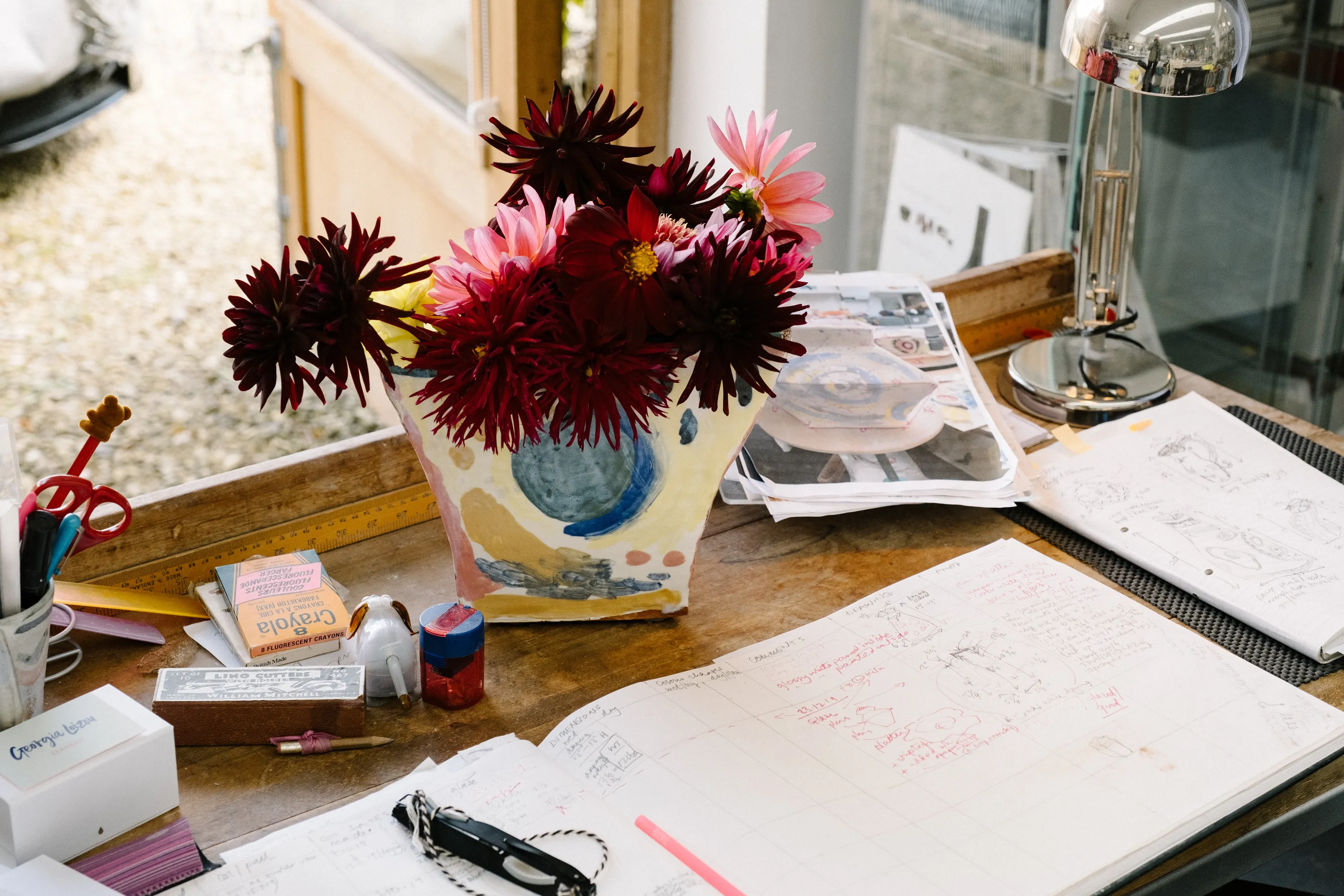 Her desk area in the studio with one of her trademark painterly pieces.